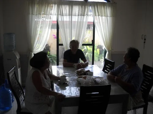 Lita, Nila and George around their kitchen table