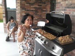 Lita helping with Pete's bar-b-que