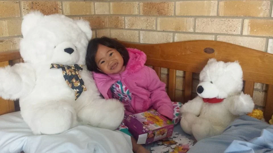Samantha with new teddy bears in Australia